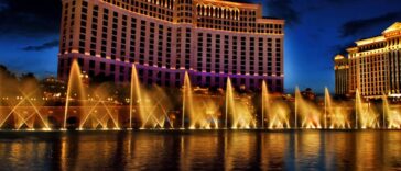 The Fountains of Bellagio in Las Vegas shoot out water at night, while the resort stands tall behind it.